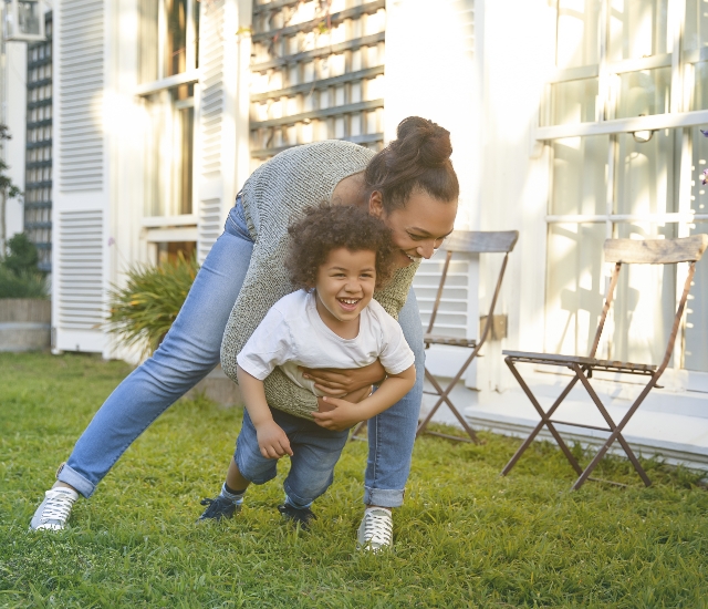 Mom and child playing in grass